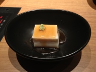 Tofu topped with a sweet sauce and wasabi